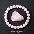 Pink crystal bracelet with a raw pink crystal on a black background