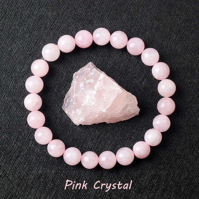 Pink crystal bracelet with a raw pink crystal on a black background