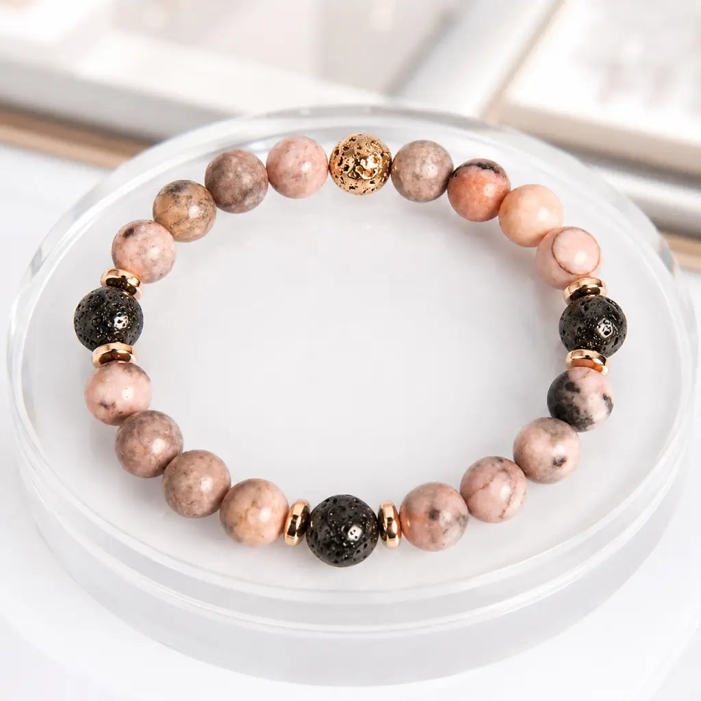 pink zebra jasper beaded bracelet with black lava stones and elegant gold details for daily wellness
