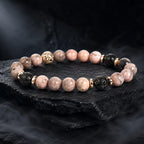 pink zebra jasper beaded bracelet with black lava stones on textured slate for premium style appeal