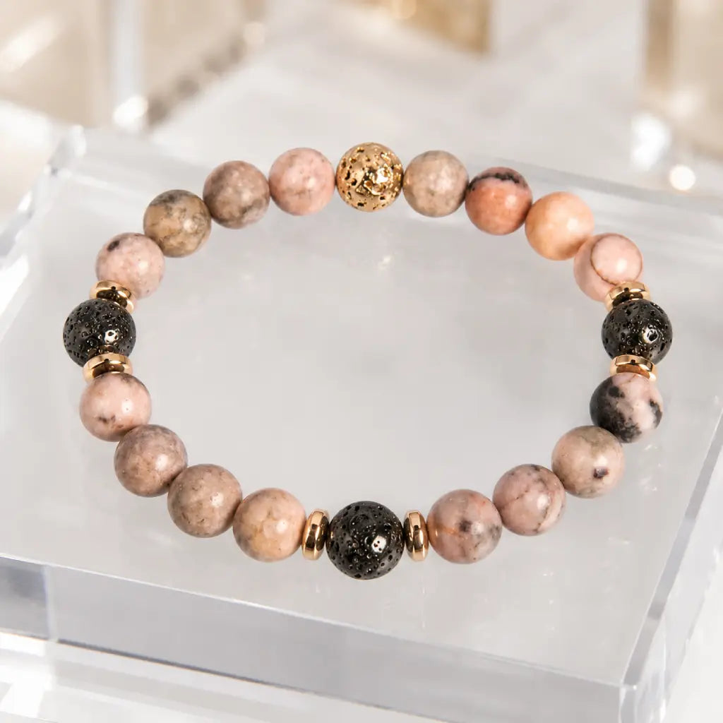 pink zebra jasper bracelet with black lava beads and gold accents for calming everyday style and wellness appeal