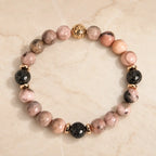 pink zebra jasper gemstone bracelet with lava beads and gold details for elegant wellness fashion appeal