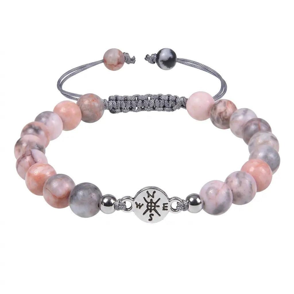 Pink Zebra Jasper beaded bracelet isolated on white background highlighting polished gemstone jewelry details