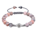 Pink Zebra Jasper beaded bracelet isolated on white background highlighting polished gemstone jewelry details