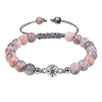 Pink Zebra Jasper beaded bracelet isolated on white background highlighting polished gemstone jewelry details