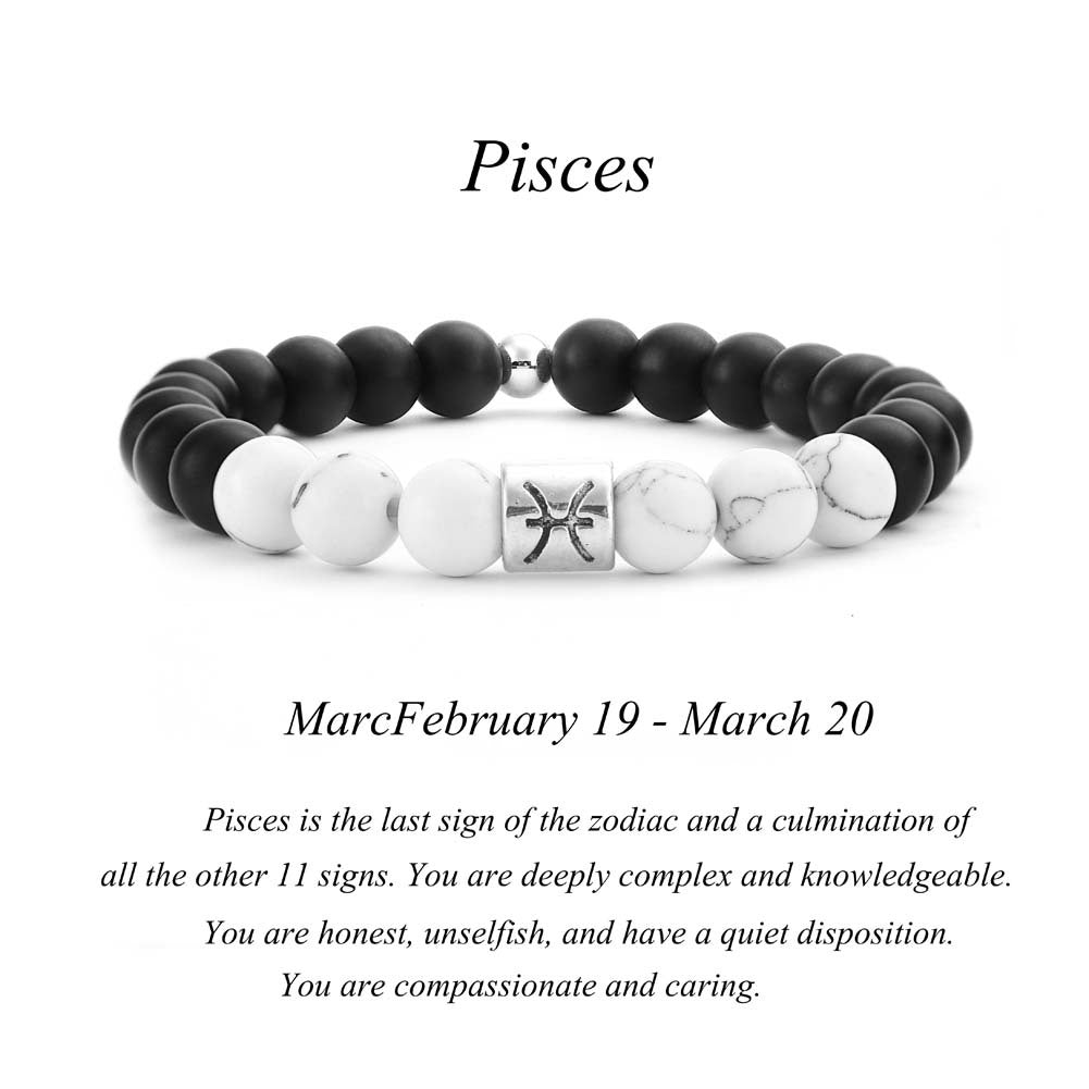 Pisces zodiac bracelet with matte black Agate and white Howlite beads and a silver Pisces fish charm on white background