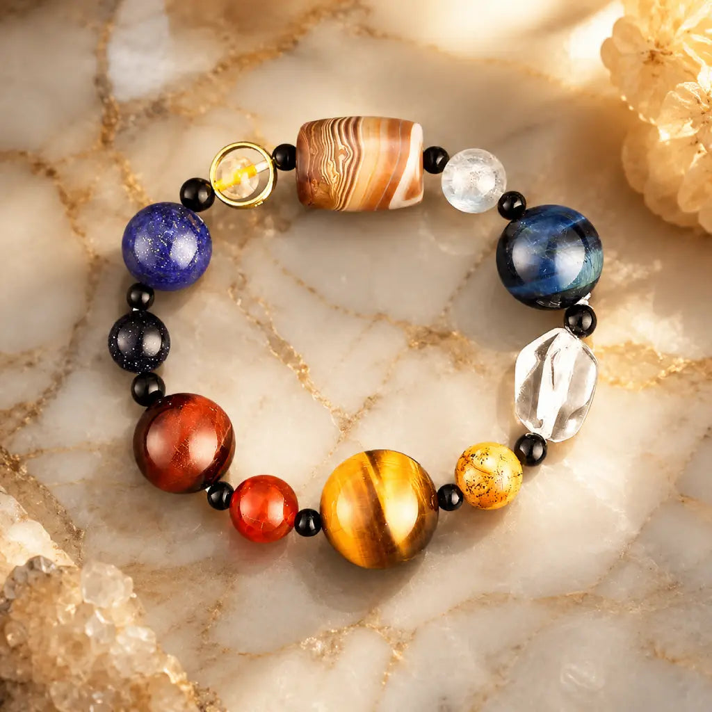 Planet bead tiger eye bracelet displayed with crystals on elegant marble, featuring colorful gemstone beads designed for style, balance, and positive energy.