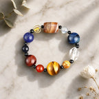Planet bead tiger eye bracelet arranged in a minimalist flat lay with natural flowers, highlighting colorful gemstone beads and premium craftsmanship.