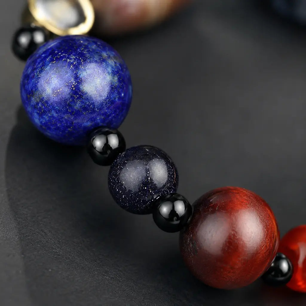 Planet bead tiger eye bracelet macro displaying vibrant lapis-inspired blue gemstone beads with polished natural stones and elegant bracelet detailing.
