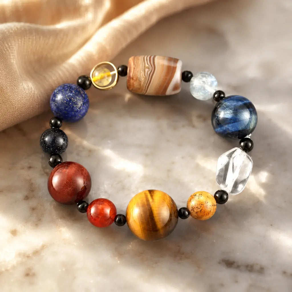 Planet bead tiger eye bracelet styled with soft golden fabric, showcasing polished natural gemstone beads for a luxurious and timeless jewelry look.