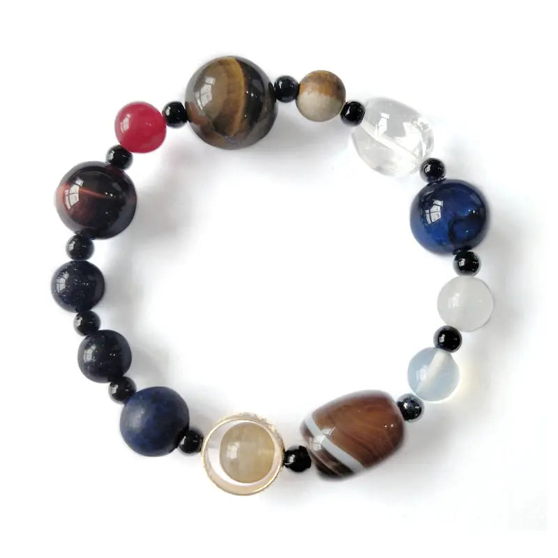 Planet bead tiger eye natural gemstone bracelet product image featuring colorful polished beads, tiger eye, quartz, and agate on a clean dark background.