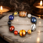 Planet bead tiger eye bracelet displayed with candles and natural gemstones, creating a calming spiritual setting for meditation and positive energy.