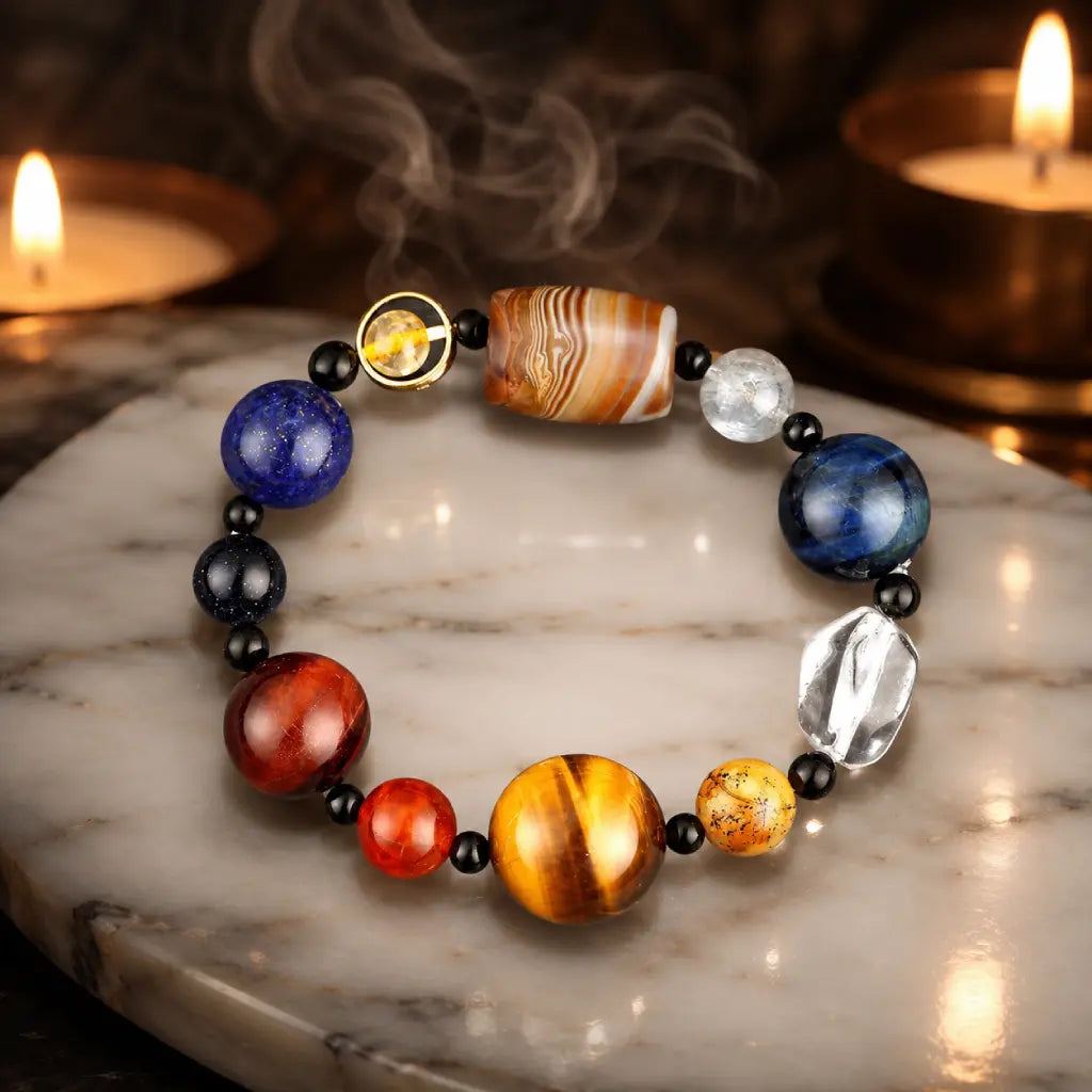 Planet bead tiger eye bracelet displayed with candles and natural gemstones, creating a calming spiritual setting for meditation and positive energy.