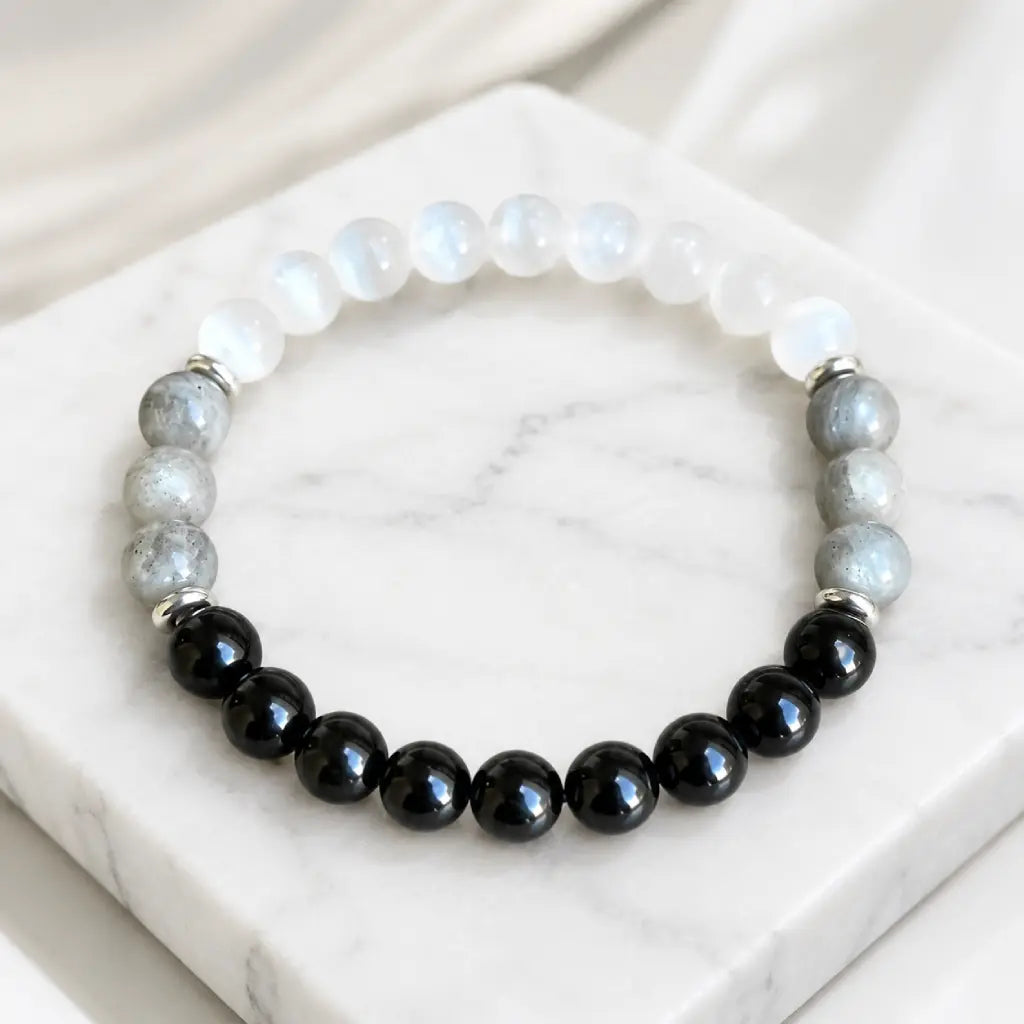 Protection bracelet with white crystal and black beads creating healing energy and stylish daily wear