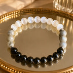Protection bracelet with white crystal and dark stone beads designed for healing energy and mindful balance