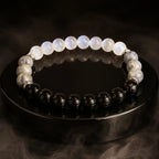 Protection bracelet displayed with dark gemstone beads and crystal jewelry for powerful energy balance