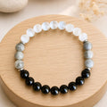 Protection bracelet on wooden display with healing crystal beads promoting balanced energy and calm focus