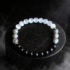 Protection bracelet with polished gemstones on dark display for spiritual energy and grounding benefits