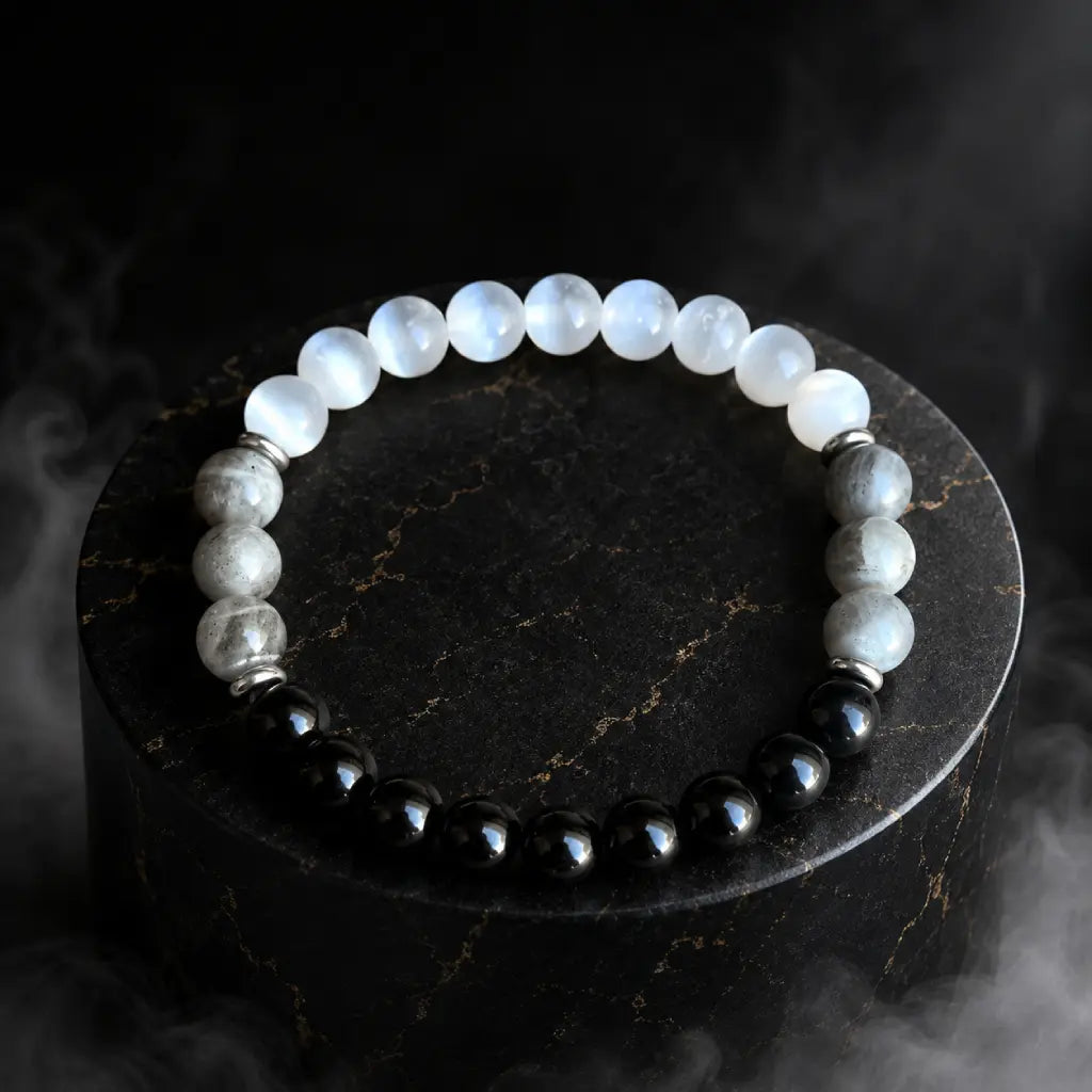 Protection bracelet with polished gemstones on dark display for spiritual energy and grounding benefits