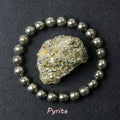 Pyrite crystal and bracelet on a dark background