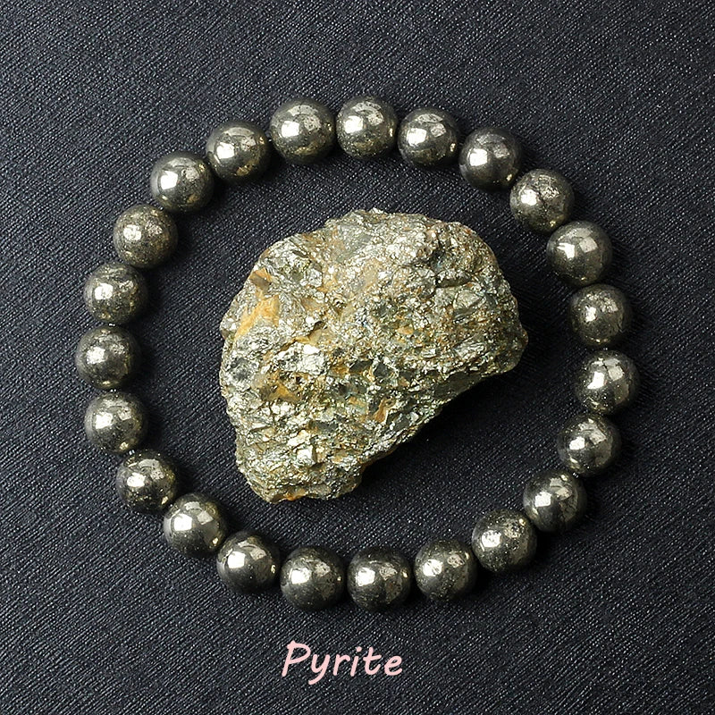 Pyrite crystal and bracelet on a dark background