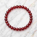 Red garnet jewelry beaded bracelet on white marble, elegant crystal accessory for stylish everyday wear daily fashion