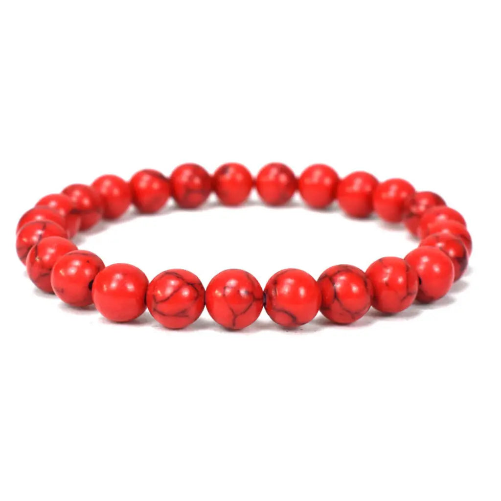 Red howlite bracelet with polished gemstone beads on a clean white background for elegant healing jewelry wear