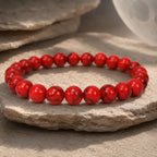 Red howlite bracelet with glossy healing stone beads displayed naturally for calming energy and daily wear