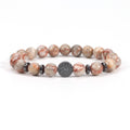 Red network bracelet with glossy 8mm cream, gray, and red-veined round beads, four black spacer rings, and one round tree-design focal bead, displayed on a bright white background.