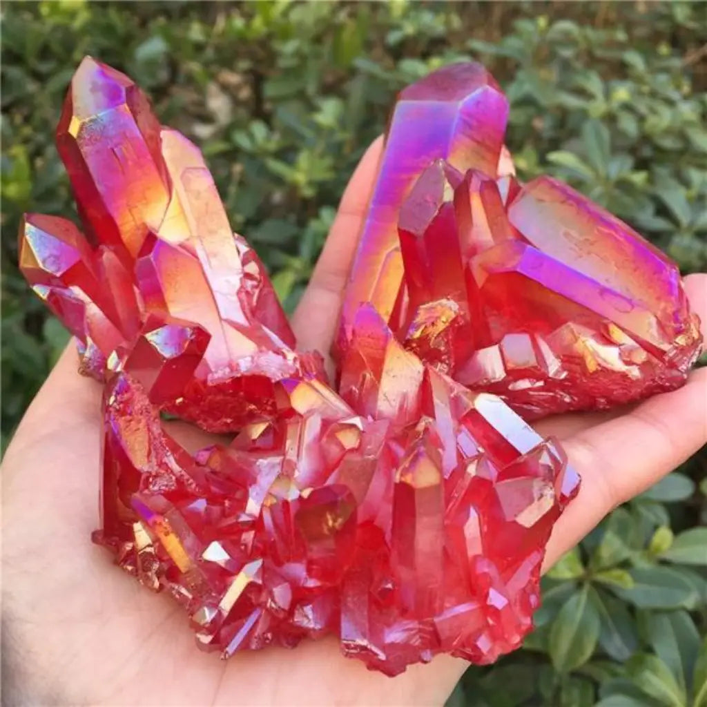 Red quartz crystal cluster with glowing red facets held in hand, striking healing crystal and decorative mineral specimen.