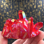 Red quartz crystal cluster featuring vibrant iridescent surfaces and natural points, stunning gemstone specimen for display collections.
