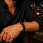 Red Tiger eye Bracelet with black lava stone beads worn by a man at night, creating a bold accessory for modern outfits.