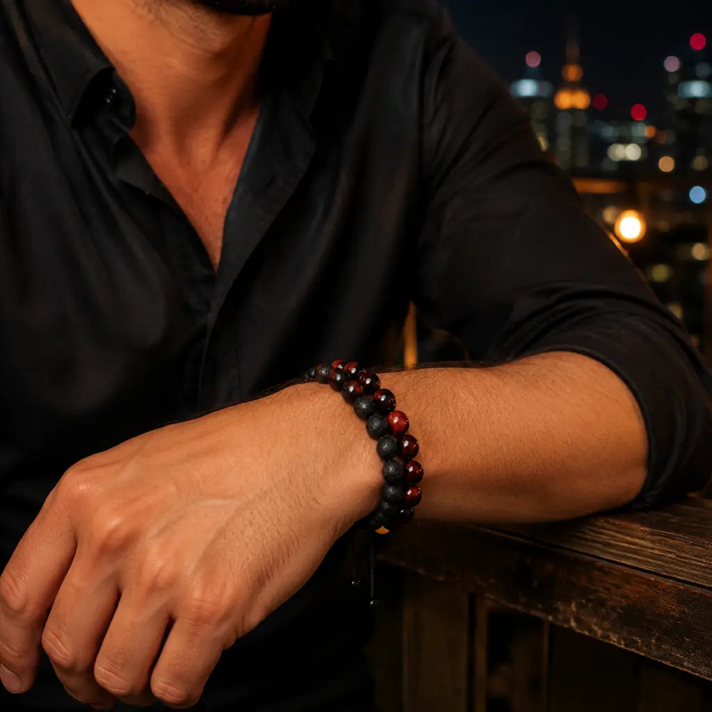 Red Tiger eye Bracelet with black lava stone beads worn by a man at night, creating a bold accessory for modern outfits.