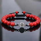 Red turquoise bracelet with glossy gemstone beads on reflective black surface for luxury styling