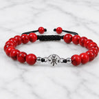 Red turquoise bracelet featuring natural stone beads on marble background with adjustable comfort fit
