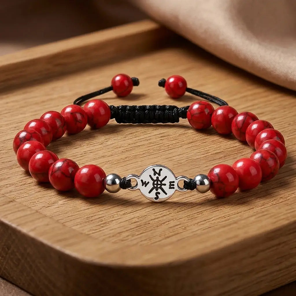 Red turquoise bracelet positioned on wooden tray with polished stone beads for modern fashion appeal