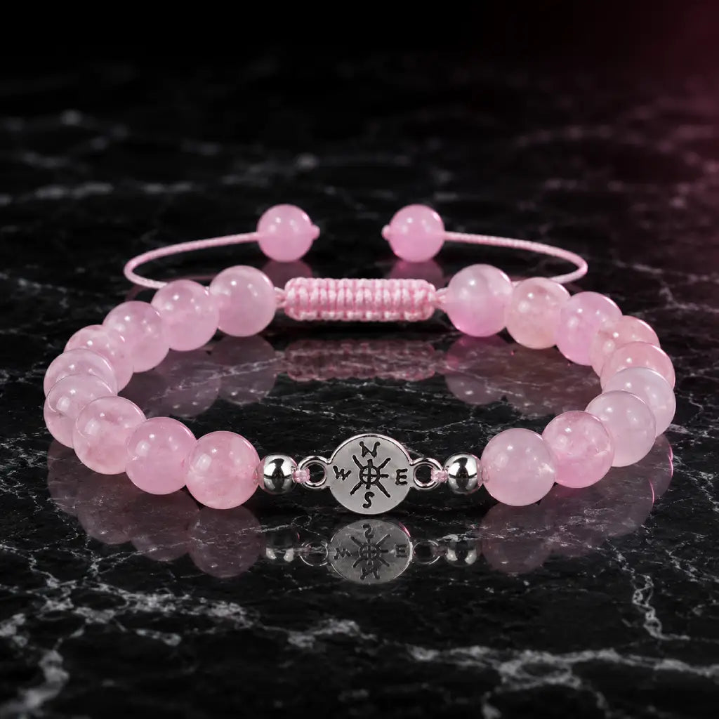 Rose Quartz crystal bracelet featuring glossy pink gemstone beads on marble surface for loving balance energy