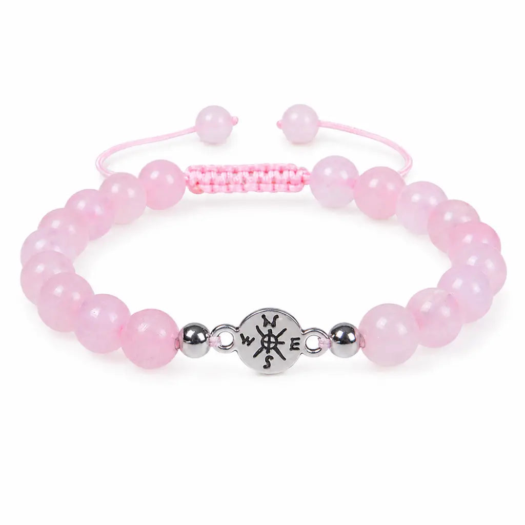 Rose Quartz crystal bracelet with polished pink gemstone beads on clean white background for healing energy style