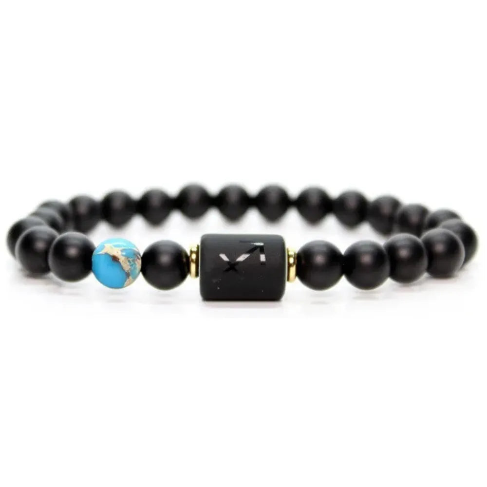 Sagittarius zodiac bracelet with matte black beads, turquoise accent bead and central engraved charm on white background