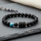 Sagittarius zodiac bracelet on black stone with decorative feather and crystal in soft neutral setting
