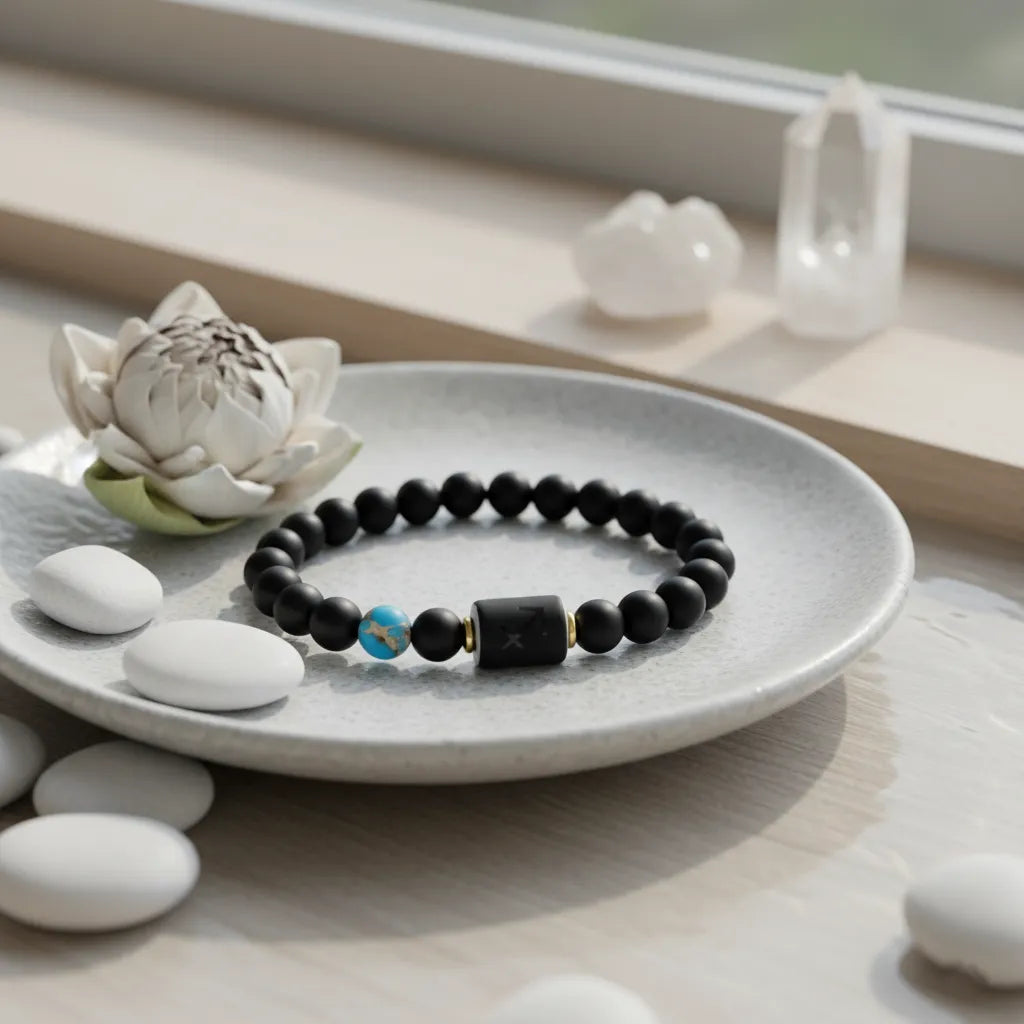 Sagittarius zodiac bracelet resting on ceramic plate with spa stones and lotus flower in calm wellness setting