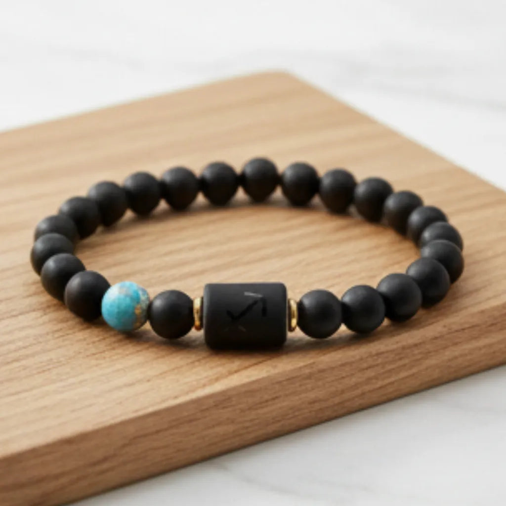 Sagittarius zodiac bracelet on dark slate with lavender detail showing matte bead texture and turquoise accent