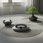 Sagittarius zodiac bracelet on smooth stone with raked sand pattern, incense and bonsai near window light