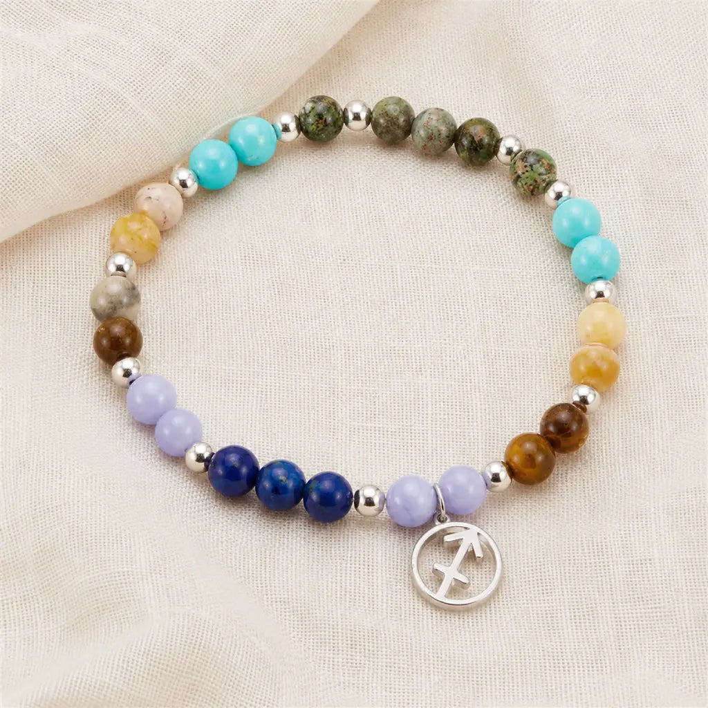 Sagittarius zodiac gemstone bracelet on soft fabric backdrop, astrology jewelry designed for meaningful gifting