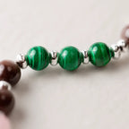 Scorpio crystal bracelet close up highlighting green malachite beads, handcrafted astrology jewelry with luxury appeal