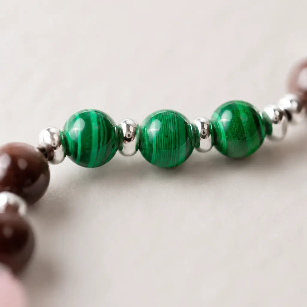Scorpio crystal bracelet close up highlighting green malachite beads, handcrafted astrology jewelry with luxury appeal