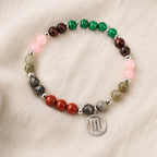 Scorpio crystal bracelet arranged on soft fabric, elegant gemstone astrology jewelry ideal for thoughtful gifting
