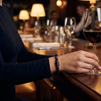 Scorpio Zodiac Bracelet styled in bar setting with wine glass, elegant astrology jewelry for evening wear and refined confidence
