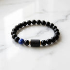 Scorpio Zodiac Bracelet on marble surface with black beads and blue stone, elegant astrology accessory for stylish everyday wear
