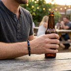 Scorpio Zodiac Bracelet worn by man holding drink outdoors, masculine astrology accessory enhancing style and personal expression